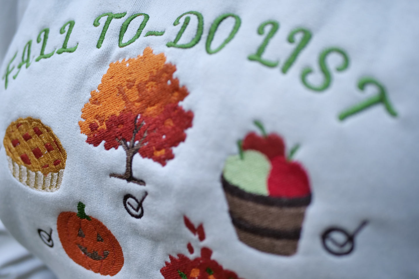 details of the embroidery for fall to do list sweatshirt