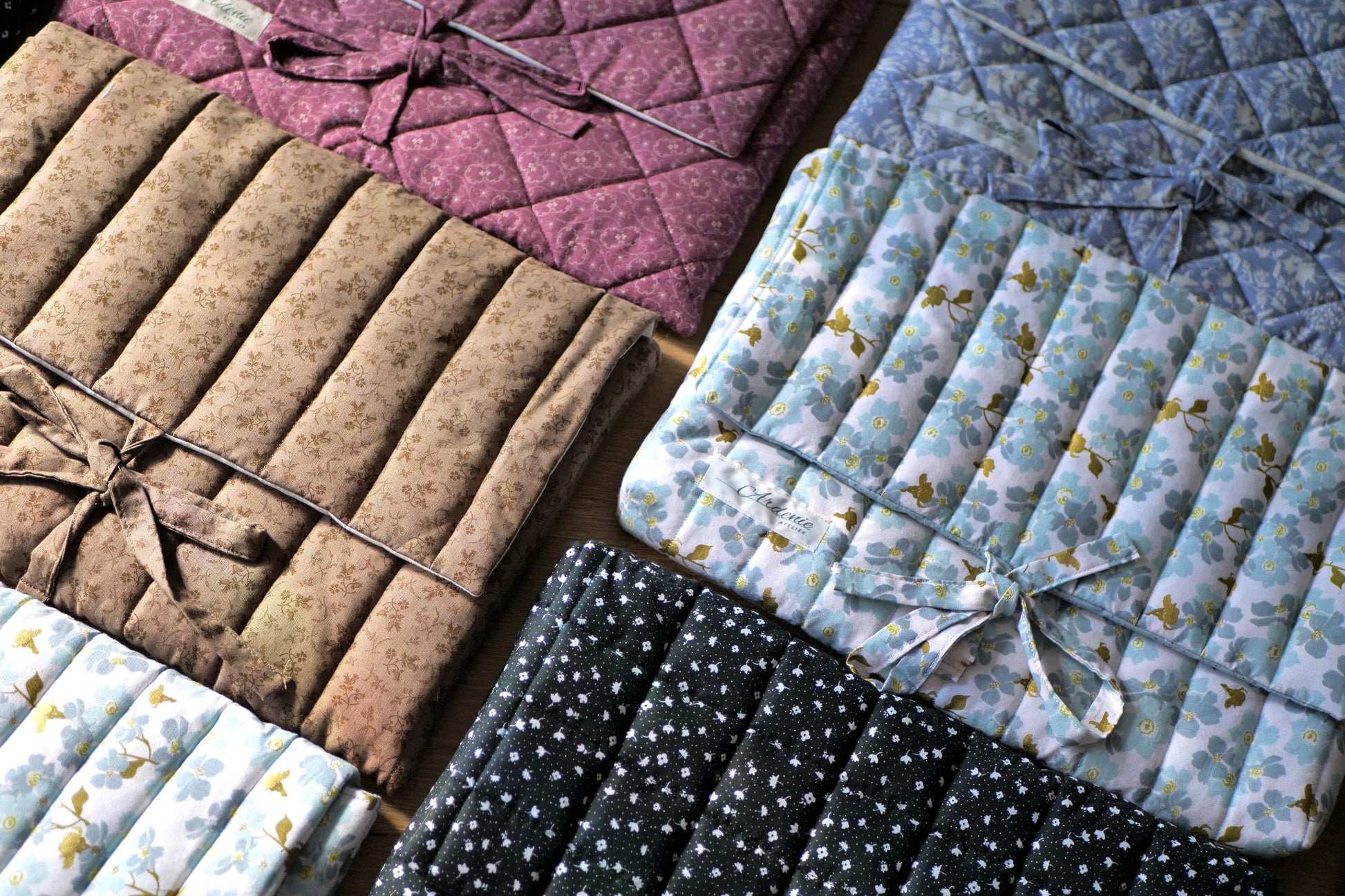 Collection of quilted fabric samples in various colors and patterns.